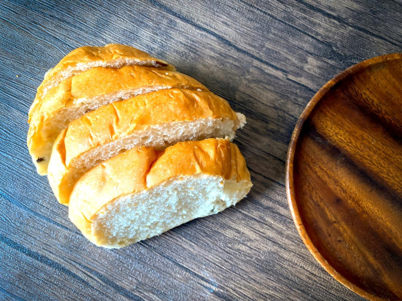 Multi-tiered celebration cake with intricate sugar flowers and smooth buttercream finish created by advanced student