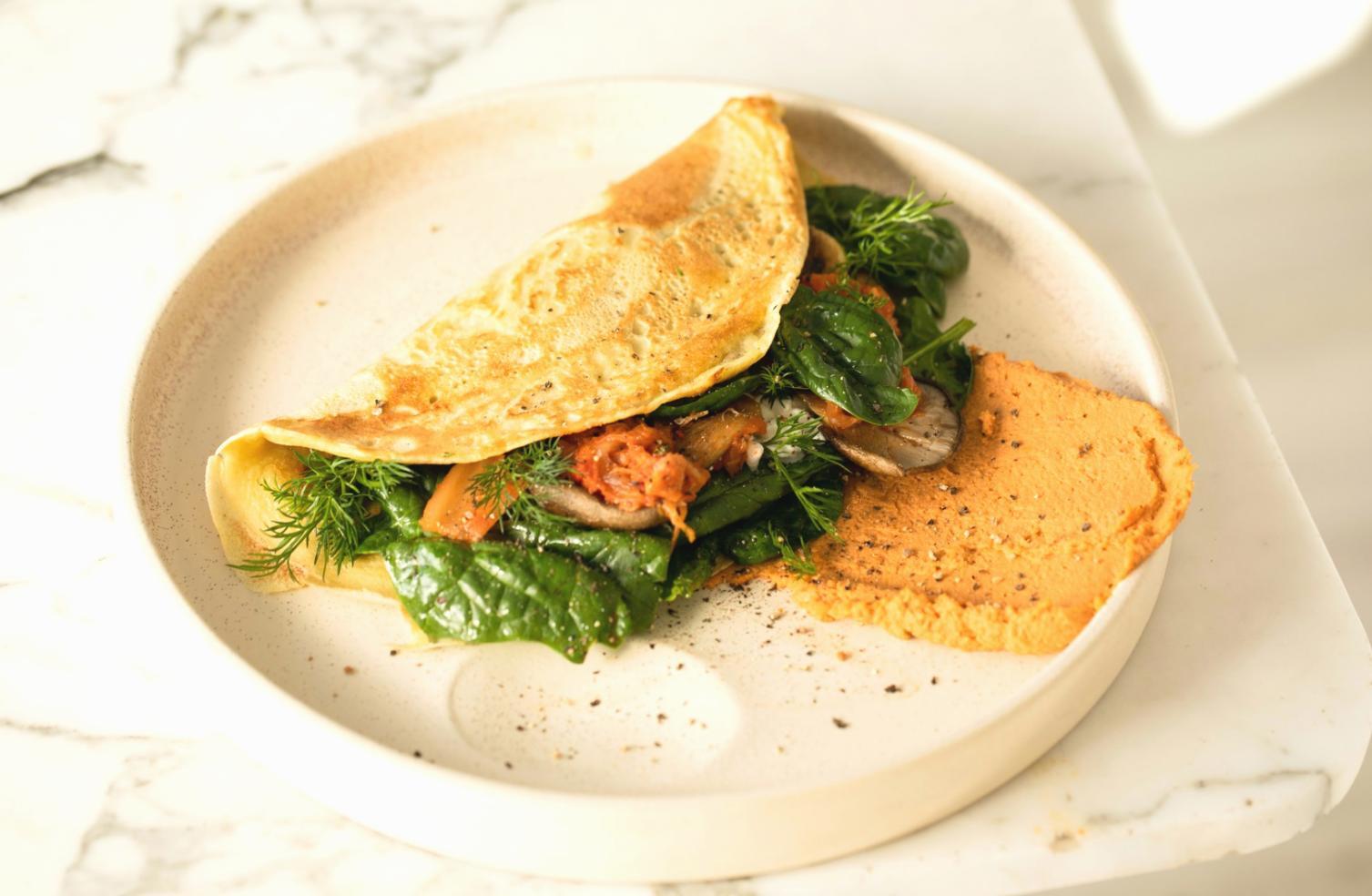 Student carefully piping decorative borders on a layered celebration cake during afternoon workshop